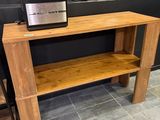 a wooden table with a microwave on top of it