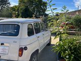 a small white car parked on the side of the road