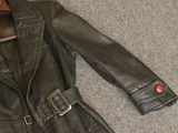 a black leather jacket with a red button on it