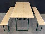 a wooden table and two benches in a room