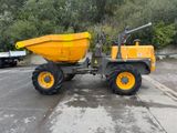 a yellow dump truck parked in a parking lot