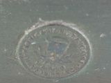 a close up of a metal plate with a seal on it