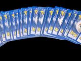 six packs of pokemon cards on a black background