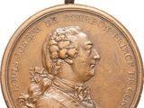 une vieille médaille en bronze sur laquelle figure le portrait d'un homme