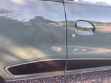 a close up of a car door with a reflection on it