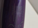 a close up of a bottle of hair product on a table