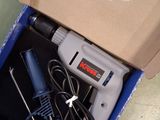 a box with a drill and a cord in it