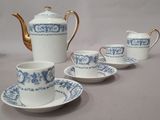 several cups and saucers are lined up on a table