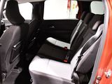 the interior of a car with the door open and the seats folded down