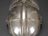 an antique silver helmet on a black background with a red star in the center