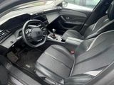 the interior of a car with the door open and the driver ' s seat down
