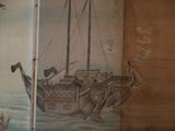 a painting of a ship on the wall of a room