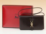 an image of a black and red purse and a red box