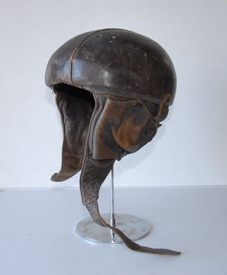 a helmet on a stand on a white surface