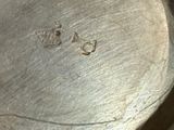 a close up of a metal object with a small hole in it