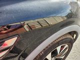 a reflection of a building in the rear of a car