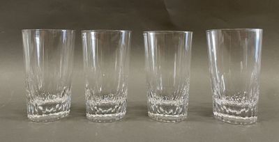 four glasses are lined up in a row on a table