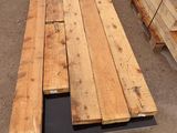 several pieces of wood are stacked on top of each other in a warehouse