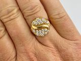 an image of a woman ' s hand holding a gold ring with diamonds on it