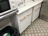 a microwave and a microwave oven in a small kitchen
