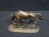statue of a horse on a base with a black background