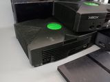 a video game console sitting on top of a desk next to a laptop