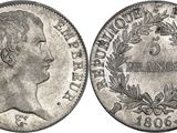 a silver coin with the head of a woman in profile