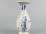 a blue and white vase sitting on a gray surface