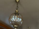 a lot of lights hanging from the ceiling in this room