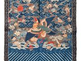 a close up of a tapestry with a bird on it ' s back