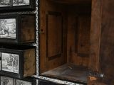 a wooden cabinet with many drawers and pictures on it