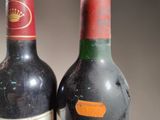 two bottles of wine sitting next to each other on a table