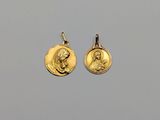 a pair of gold - plated earrings depicting the virgin and child