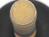 a close up of a bottle of wine on a black plate