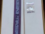 a picture of a ruler and a necklace in a box