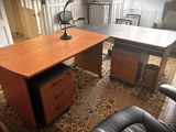 a desk with a lamp and a chair in a room