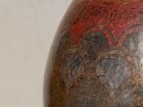 a vase that is sitting on a table in front of a wall