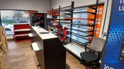 an image of a store with a lot of shelves and desks