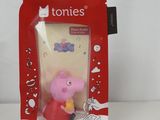 a pink toy in a red package on a white surface