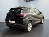 the rear end of a black car in a showroom