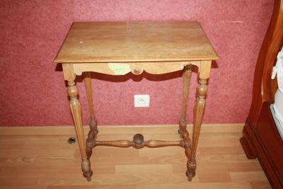 a small wooden table with a drawer on top of it