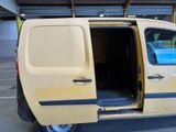a yellow van with its doors open in a parking lot