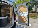 a white van with the door open and a trash can in the back of it