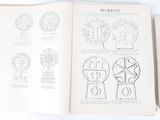 an open book with drawings on it on a white surface