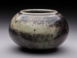a black and white vase sitting on a table