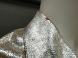 a close up of a shiny silver jacket on a mannequin mannequin
