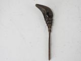 a long wooden stick with a bird ' s head on it