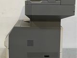 a black and white printer sitting on top of a gray printer