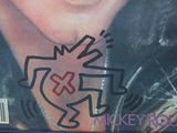 graffiti on the cover of a magazine with a picture of a man ' s face on it