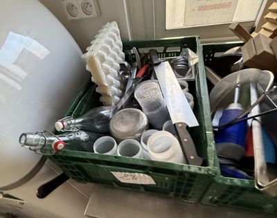 a green container filled with assorted items on a counter